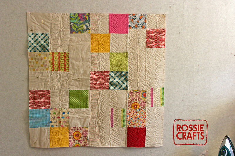 practicing a variety of quilting designs on a simple quilt top