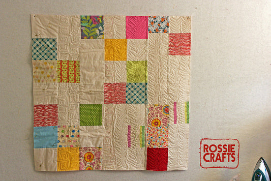 practicing a variety of quilting designs on a simple quilt top